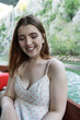 Happy young girl in a small boat smiling with summer clothes. Tourist white skin Woman red head in a canyon enjoying a excursion with a canoe. Green water and nature in Matka. Journey in a river