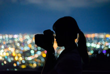 Silhouette Woman Taking Picture With Dslr Camera At Night In Thailand.
