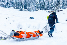 Ski Patrol Team Rescue Woman Skier With Broken Leg