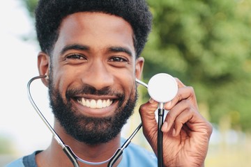 Wall Mural - Beautiful happy doctor outside in the park