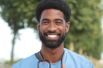 Beautiful happy doctor outside in the park