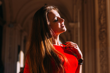 Wall Mural - Close-up of a girl with long hair closed her eyes. sunlight. pro