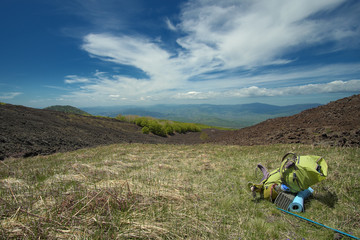 Wall Mural - Green Backpack In Mountain Landscape