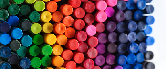 box of crayons in a rainbow of colors background