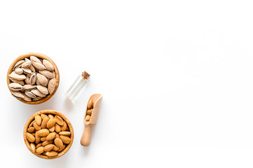 Almond in bowls for cooking oil on white background top view mockup