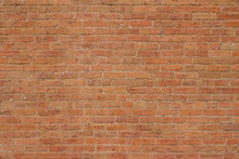Old Reddish Orange Brick Wall Background With Cracks And Worn Texture