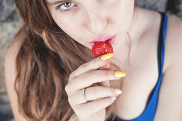 Wall Mural - Girl eating strawberry.