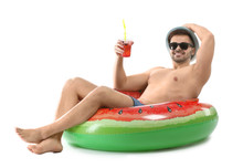 Happy Young Man With Inflatable Ring And Cocktail On White Background