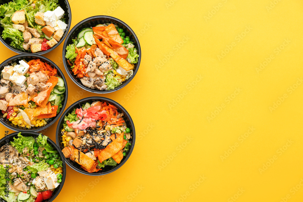 Many containers with delicious food on color background - obrazy, fototapety, plakaty 