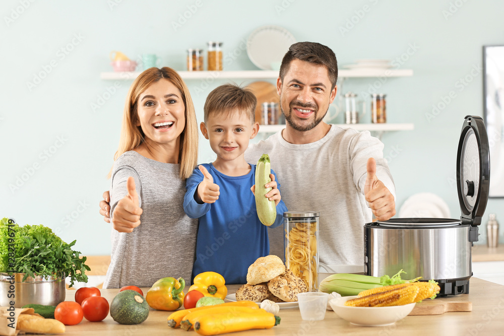 Happy family with modern multi cooker showing thumb-up gesture in kitchen
