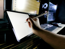 Male Hand Drawing Illustration On Pro Tablet Next To Gaming Workstation Pc