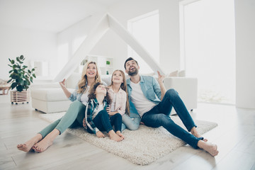 Wall Mural - Photo of young family adopted two children move new apartments hold hands paper roof hoping best future