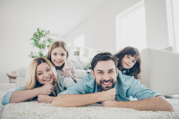 Poster - Photo of four members adopted family lying floor toothy smiling fluffy carpet cozy apartments