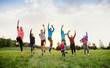 © Halfpoint - A large group of multi generation sport people standing in nature, jumping.