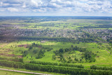 Fototapeta Na sufit - Green fields and forests, blue sky and white clouds background panoramic  aerial view, sunny summer day europe nature landscape top view, beautiful grassland meadows and trees panorama look from above