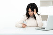 © burdun - Sad and stressed woman in office sitting at the table and working till late