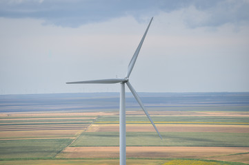 Wind turbines in a wind farm with a dramatic stormy sky in the background