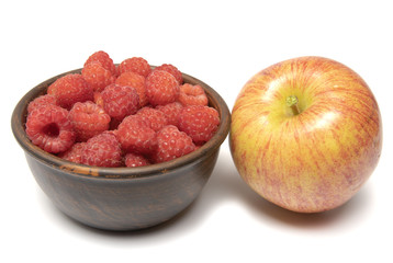  apple and raspberries in a cup on a white background