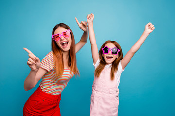 Wall Mural - Funny foxy little lady and her mom cheerleading favorite team wear casual clothes isolated blue background