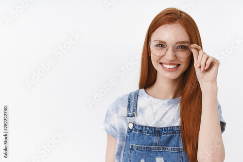 Cuadros en Lienzo Cheerful smiling redhead, young girl grinning confident checking transparent gla