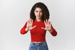 © Cookie Studio - Stop right there no more. Serious-looking confident strong woman femenist fighting equal rights demanding hold stretch palms taboo warn gesture look serious self-assured prohibiting action