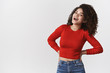 © Cookie Studio - Carefree lively happy modern stylish female model curly dark hairstyle laughing cheerful rejoicing have perfect weekend mood standing joyfully hold hands confident waist, standing white background