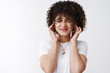 © Cookie Studio - Cute girl cringing cannot stand loud places wrinkle nose feel disturbed close ears index fingers distracted cannot focus neighbours threw party unwilling hear noise, white background