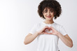 © Cookie Studio - Love exist out hearts. Caring tender attractive smiling romantic queer girl show heart gesture hands grinning confess sympathy wish happy pride standing white background delighted