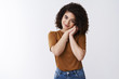 © Cookie Studio - Cuteness overload. Attractive charming sensual tender young curly-haired 20s girl sighing romantically lean hands tilting head cute smiling look camera lovely standing white background