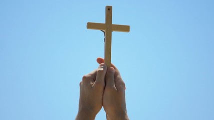 Poster - Hands holding cross against sky background, christian baptism, spirituality