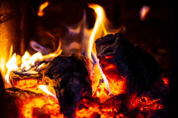 The firewood burns in the furnace, the fire is brightly red.