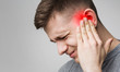 Young man has sore ear, suffering from otitis