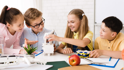 Poster - Happy children constructing robotic device at stem class