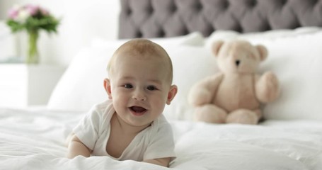 Wall Mural - Adorable little child lying on bed at home