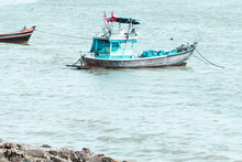 Small Blue Fishing Boat In The Sea.