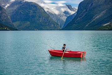 Woman fishing on a boat.