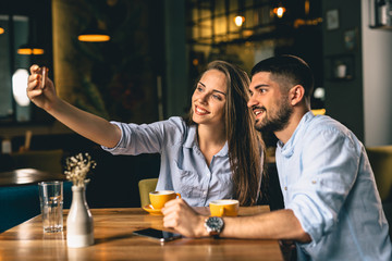 Wall Mural - man and woman taking picture in cafeteria