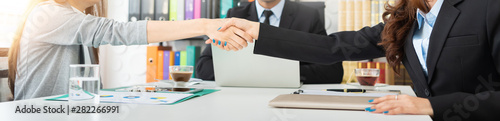 Fototapeta  Successful Two Asian businesswomen shaking hands.