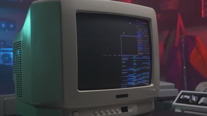 hacking screen with coding on a retro old computer monitor or TV from the 90s 80s