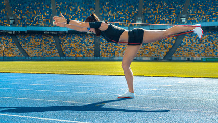 Wall Mural - Sportswoman stretching before run on stadium