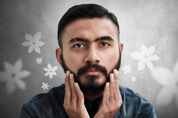 Wall Mural - Handsome bearded man touching his beard