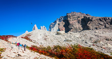 Panoramic View Of Torres Del Paine National Park, Its Forests And Summits At Golden Autumn And Group Of Hikers And Flying Condors In Blue Sky Above, Patagonia, Chile, Sunny Day