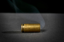 Smoking Bullet Casing Dropped On The Ground