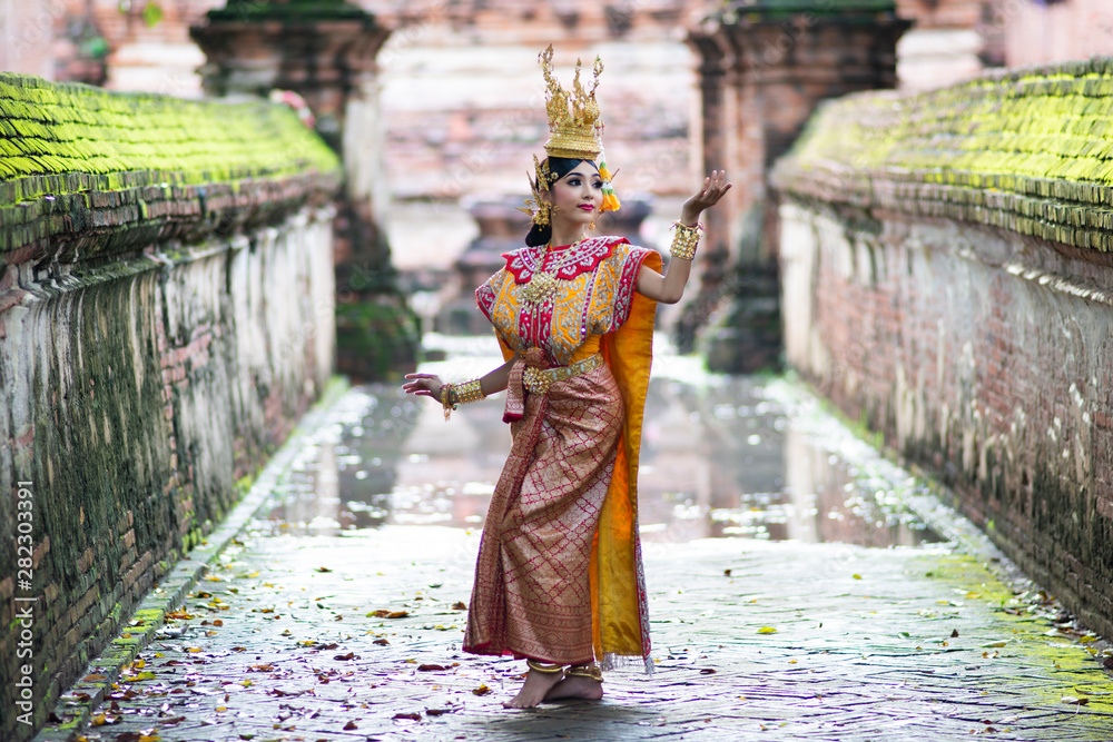 Thailand traditional or cultural dance. Thai beautiful girl is dancing called Ram, it is noble Thai art of elegance. - obrazy, fototapety, plakaty 