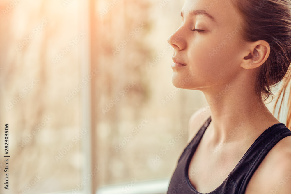 Young woman doing breathing exercise - obrazy, fototapety, plakaty 