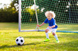 © famveldman - Kids play football. Child at soccer field.