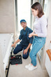 © pressmaster - Young woman and technician of repair service discussing new installed system