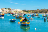 Fototapeta  - The traditional eyed boats in the harbor of fishing village Marsaxlokk in Malta