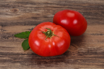 Ripe tomato over wooden background