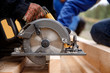 © Parilov - Builder uses portable circular saw tool to cut wood